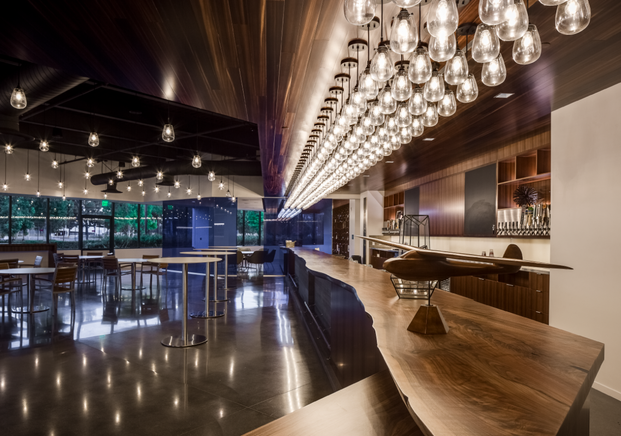 Bar Area with Wood and Lights at Harbor Distributing Beverage Facility and Headquarters Built by ARCO Construction