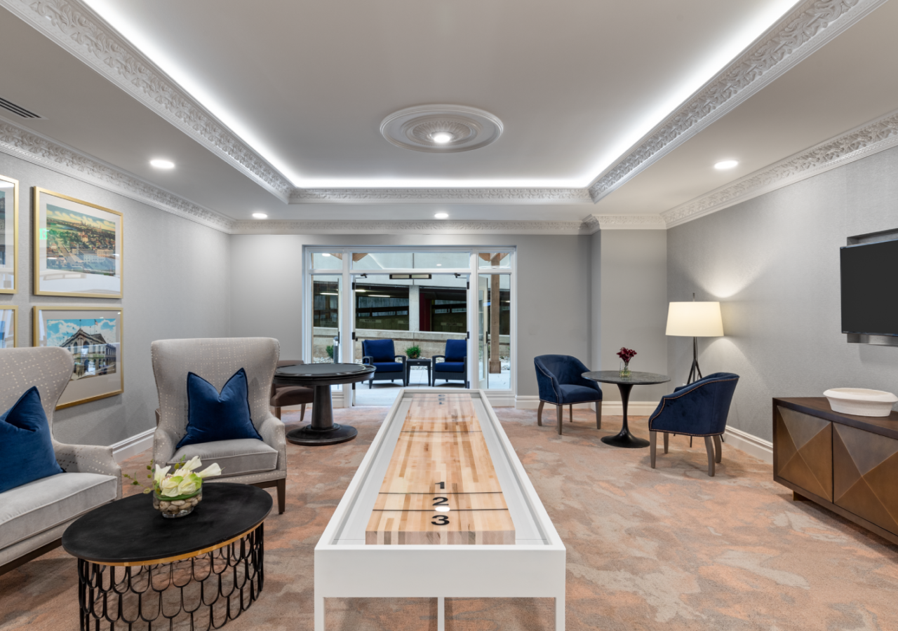 Game Room with Tabletop Shuffleboard at Stonecrest Senior Living at the Plaza Built by ARCO Living Group