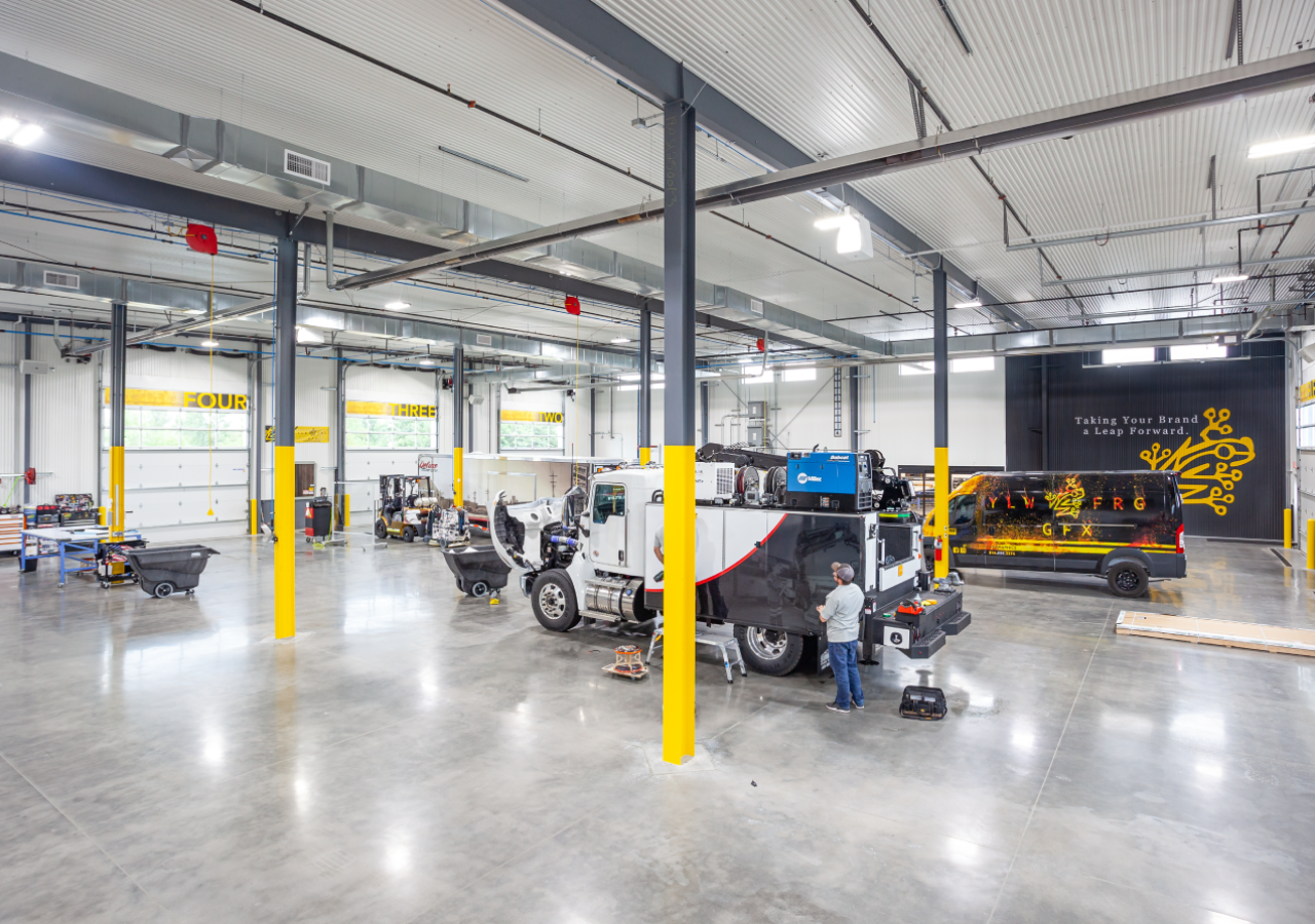 Showroom with Trucks and Art at Yellow Frog Graphics Facility Built by ARCO Construction