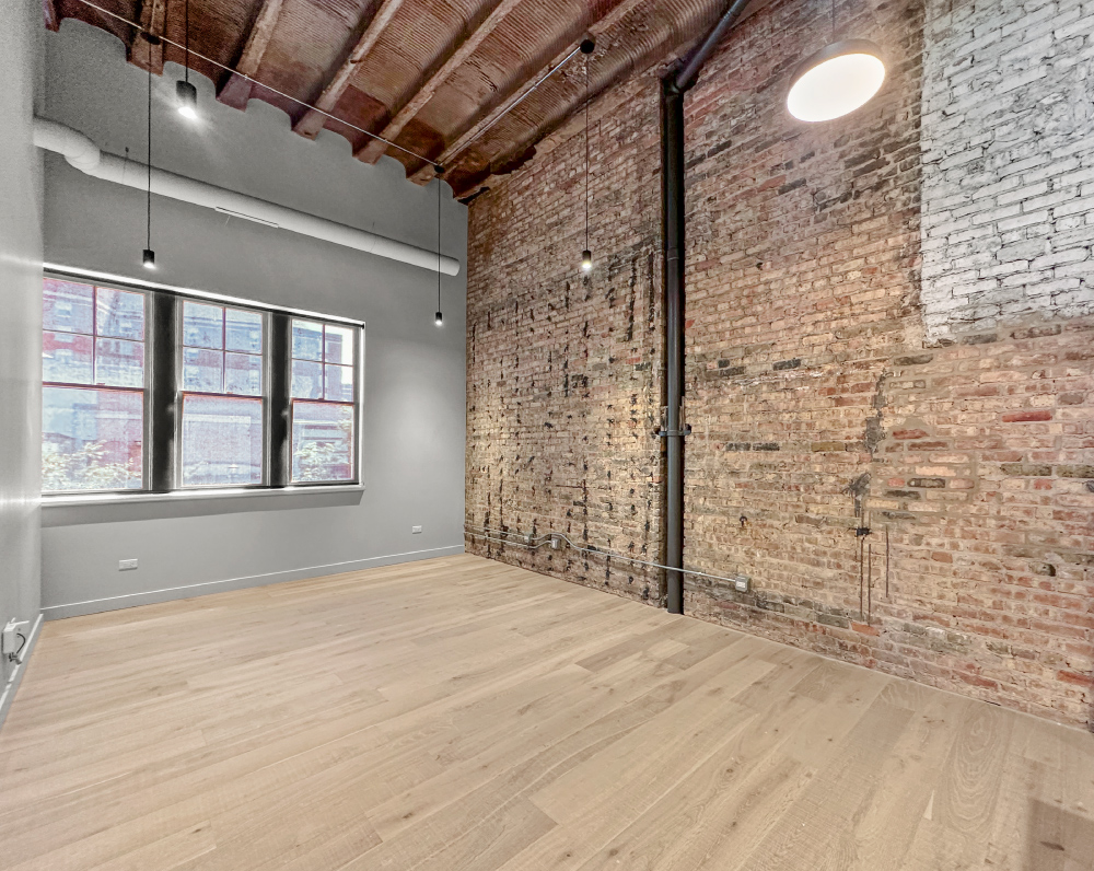 exposed brick wall within a unit of the varsity theater conversion in evanston illinois