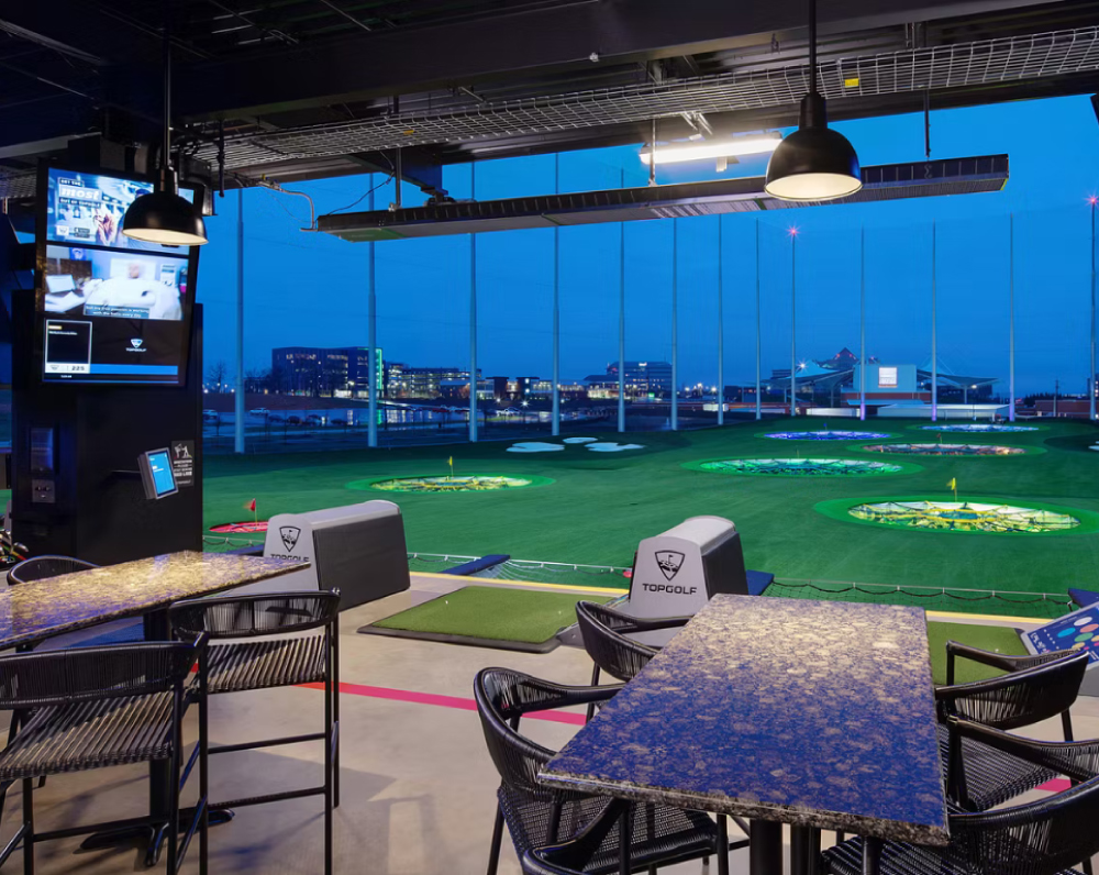 looking out of a hitting bay of the rodgers arkansas topgolf complex